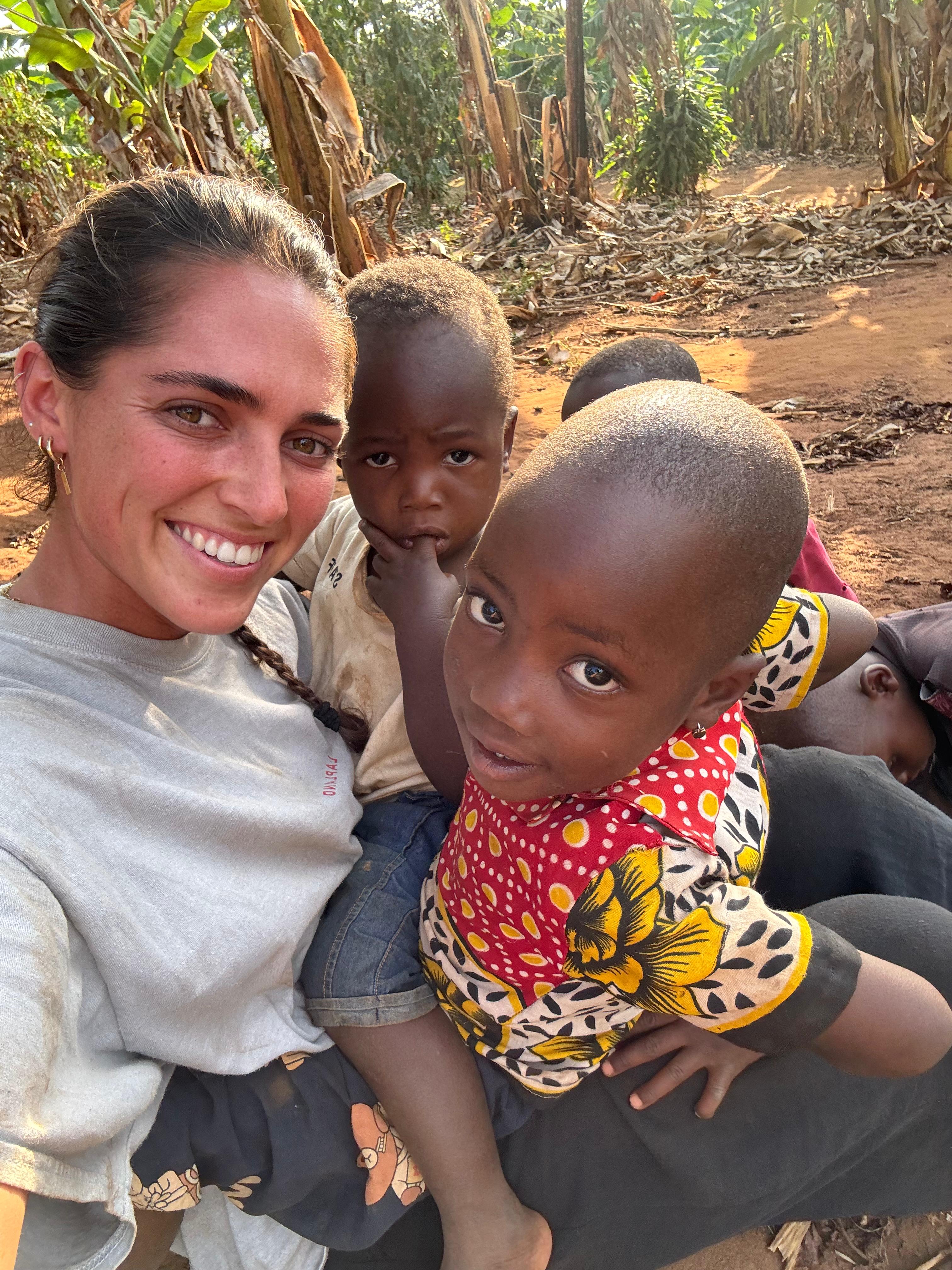 Ella with children in Tanzania